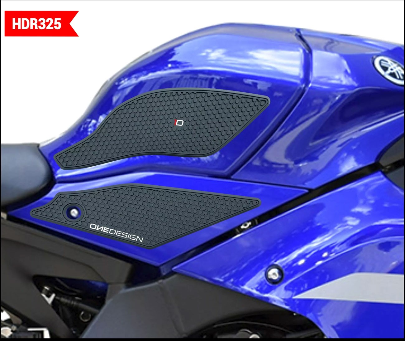 Black rubber tank grip pads with a honeycomb texture, featuring a subtle logo, applied to a vibrant blue motorcycle tank.