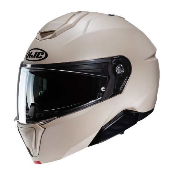HJC I91MSM motorcycle helmet in matte sand beige, featuring a flip front design, tinted visor, and sleek aerodynamic shape with a black trim.