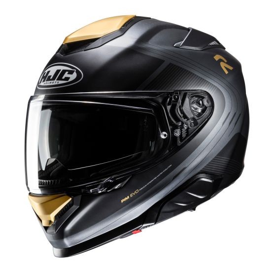 Black full face motorcycle helmet with a glossy finish, gold accents, aerodynamic shape, and a clear visor, featuring HJC branding and ventilation ports.