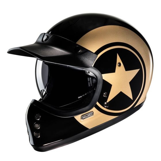 HJC V60 Graphic Motorcycle Helmet in Nyx Gold features a glossy black and gold finish with a prominent star design, a clear visor, and ventilation ports, sized 2X-Large (62-63cm).
