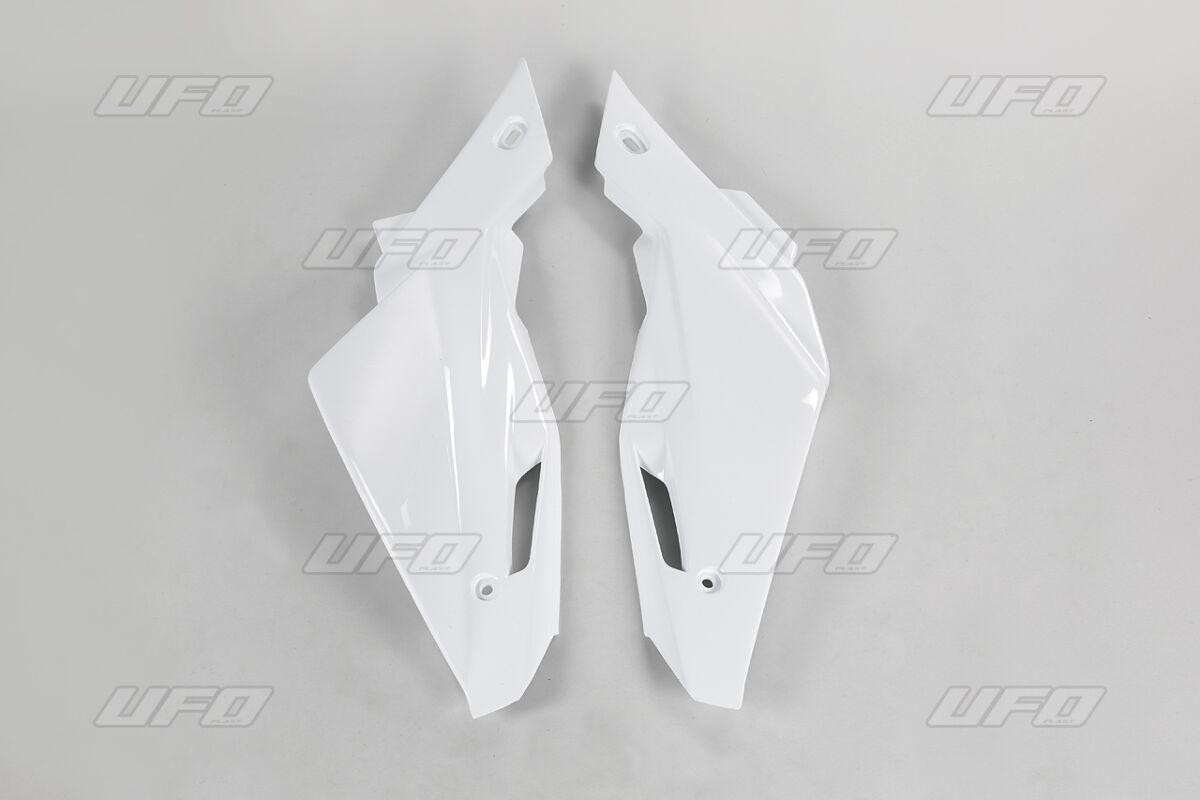 White plastic side panels designed for Husqvarna TC 250-510 (2008-12) and TE 250-310 (2011-12) motorcycles, featuring a sleek, aerodynamic shape with mounting holes.