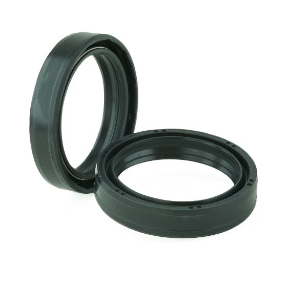 Two black K-Tech motorcycle fork oil seals made of durable rubber, featuring a smooth surface and a circular design with a central opening for easy installation.