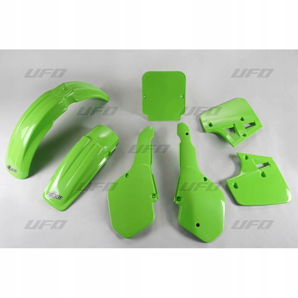 Bright green plastic kit for Kawasaki KX250 1987, including front fender, rear fender, side panels, and number plate, all featuring a glossy finish.