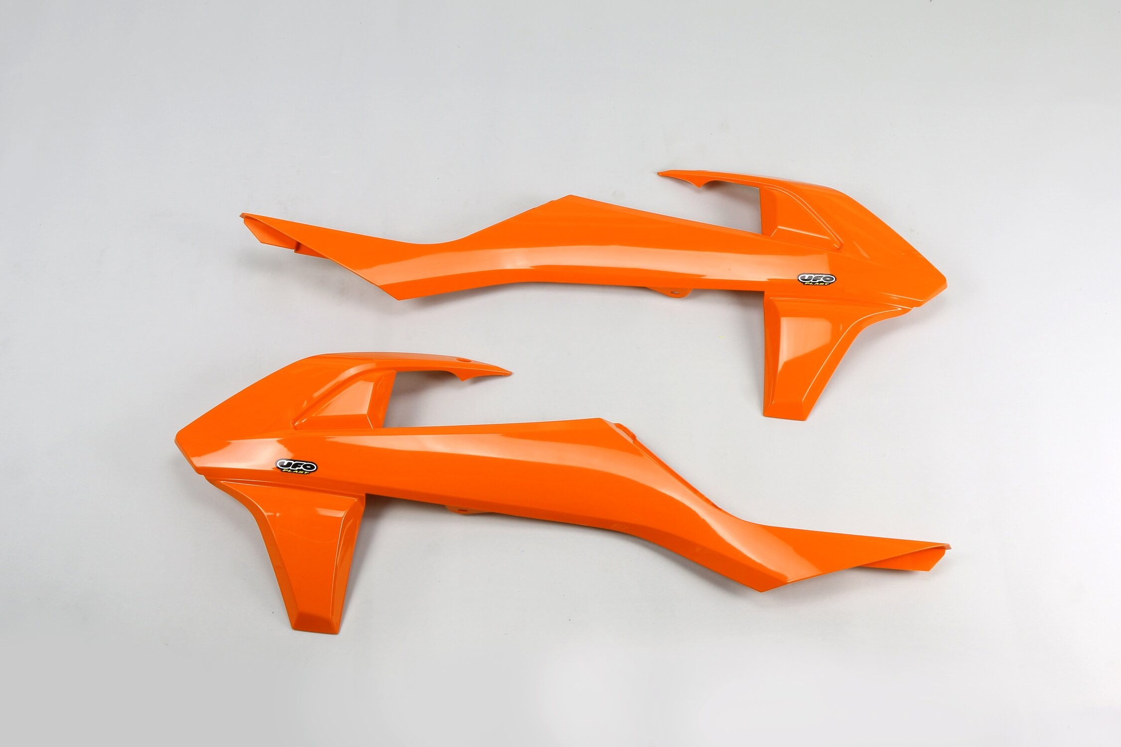Bright orange plastic radiator scoops designed for KTM EXC-F 2017-18 and SXF 2016-18, featuring a sleek aerodynamic shape and the UFO logo.