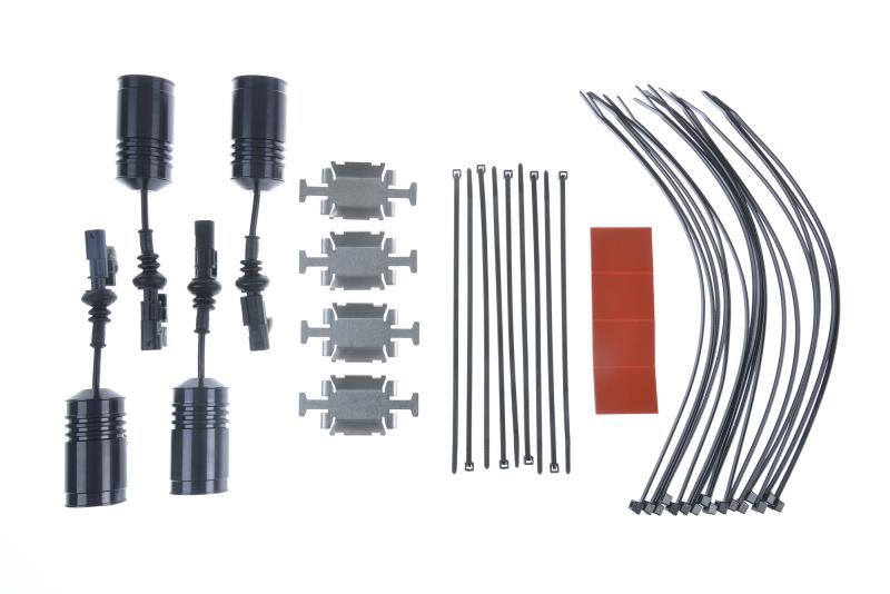 KW Suspension Electronic Suspension Cancellation Kit includes four black electronic connectors, four silver brackets, zip ties, and adhesive pads, all designed for suspension systems.