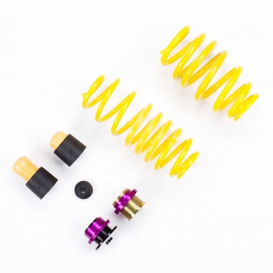 Yellow coil springs with purple and black components, including rubber bump stops and adjustment collars, designed for height adjustment in vehicles.