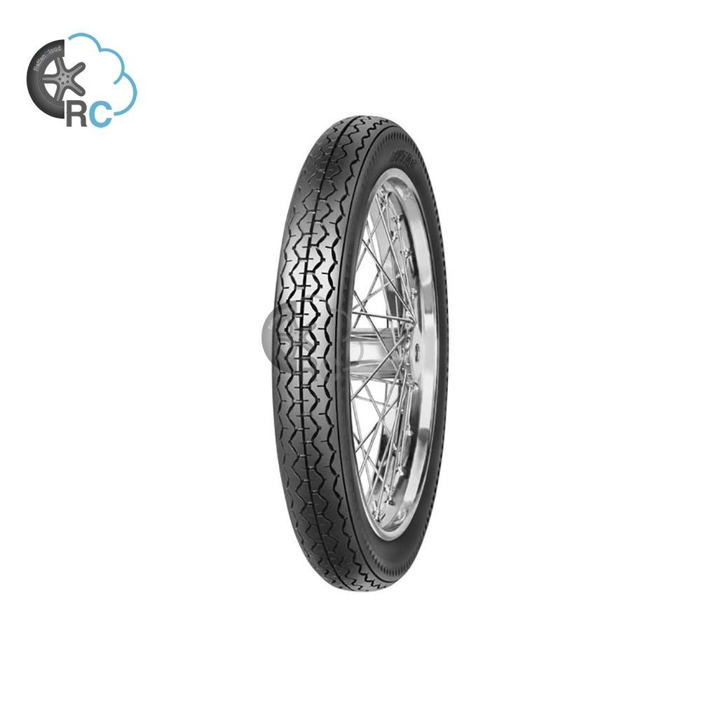 Mitas H-06 motorcycle tyre in black rubber, size 3.25 19 (54P) TT, featuring a tread pattern designed for enhanced grip, mounted on a silver-spoked wheel.