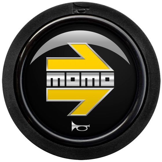 Gloss black horn push button featuring a prominent yellow Momo logo and arrow design, encased in a circular black housing with two contact points.