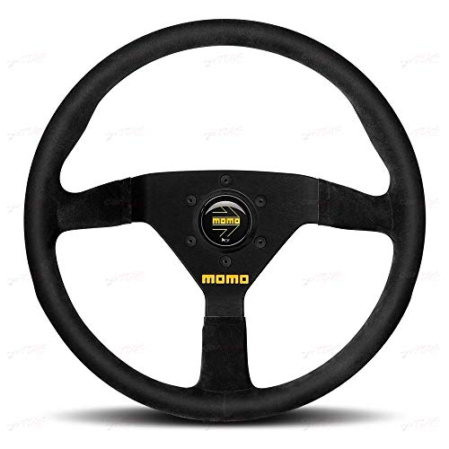 Black suede steering wheel with black spokes, featuring a central Momo logo and a sporty design, measuring 320 mm in diameter.