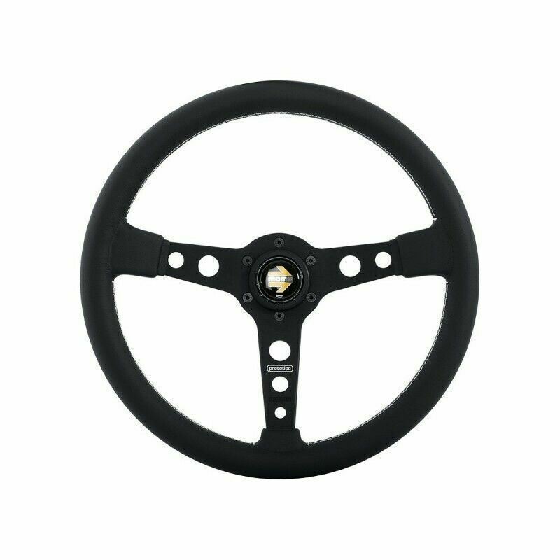 Black Momo Prototipo steering wheel, 370mm diameter, featuring a smooth leather grip, three spokes with cutouts, and a central horn button.