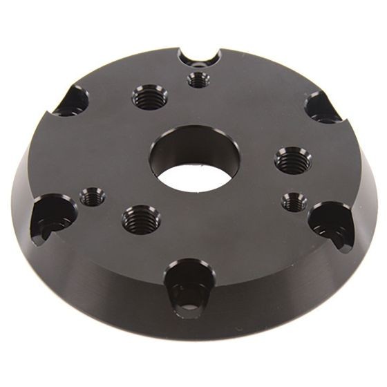 Black aluminum steering wheel adaptor with a circular design, featuring six bolt holes and a central opening, designed for compatibility between 6 and 3 bolt steering wheels.