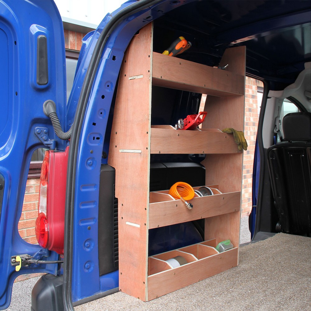 Brown wooden shelving unit with three open shelves and compartments, designed for the interior of a Citroën Berlingo II SWB van, mounted against a blue van wall.