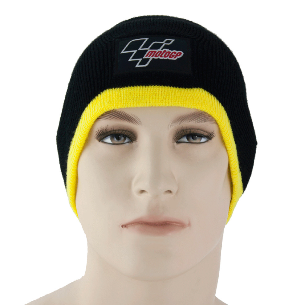 Black thermal beanie hat with a yellow cuff, featuring a MotoGP logo patch on the front, made from soft material, ideal for warmth and style.