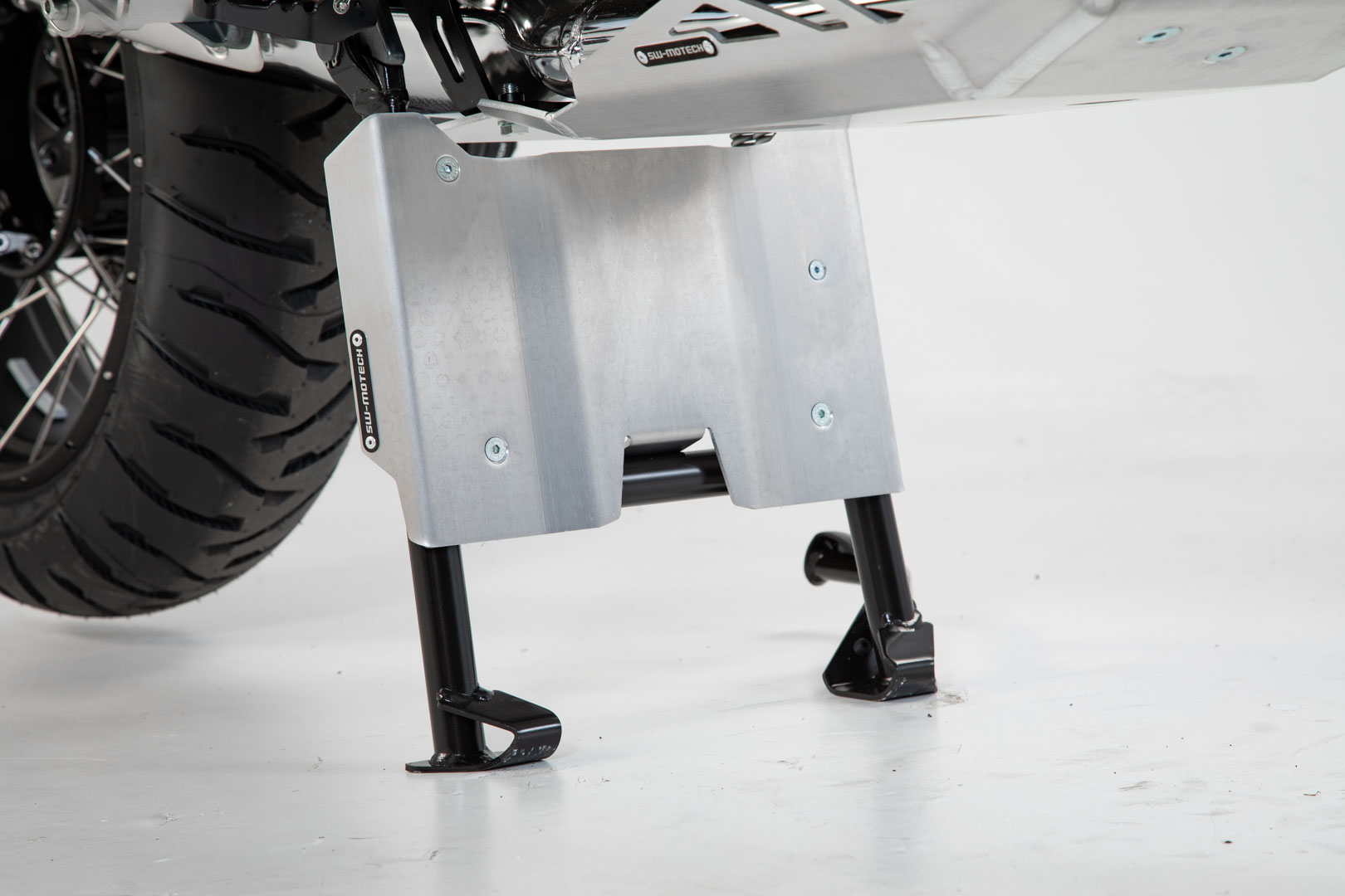 Silver aluminum engine guard extension for BMW R 1250 GS, featuring a sturdy design with black mounting brackets and visible screw holes for secure attachment.