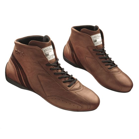 Light brown OMP Carrera race boots in size UK 9.5 / EUR 44, featuring a high-top design, leather material, black laces, and signature OMP branding on the side.