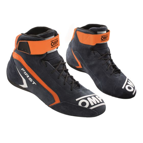Navy blue and orange OMP First Race Boots, size UK 8/Eur 42, featuring a high-top design, Velcro strap, and a sleek, sporty look suitable for racing.