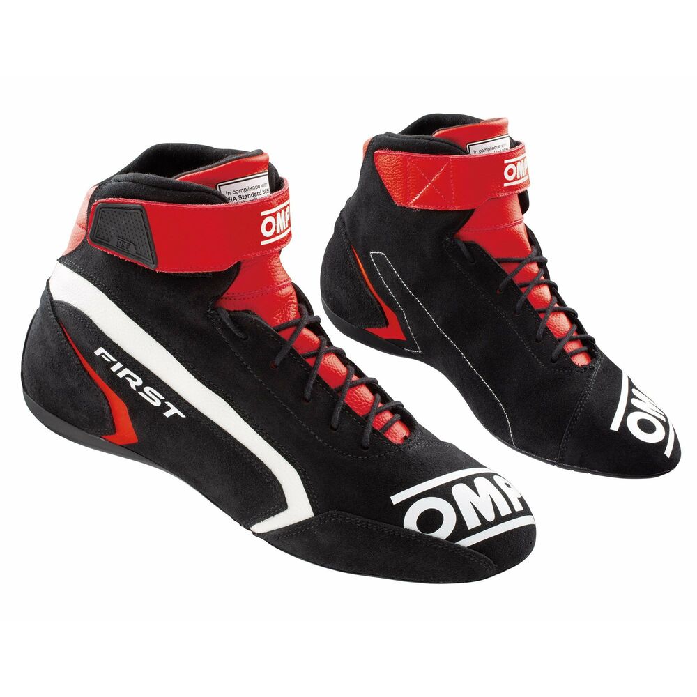 Black and red OMP First Race Boots, UK size 9.5 / EUR 44, featuring a high-top design, suede material, lace-up front, and bold branding on the sides.