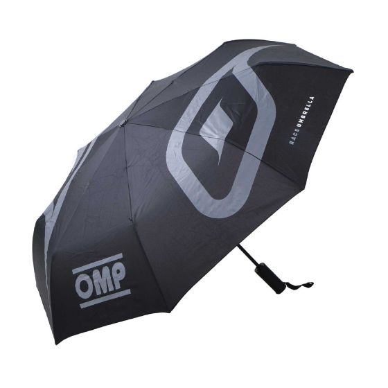 Black foldable umbrella featuring a large gray OMP logo and a sturdy handle with a wrist strap, designed for durability and portability.