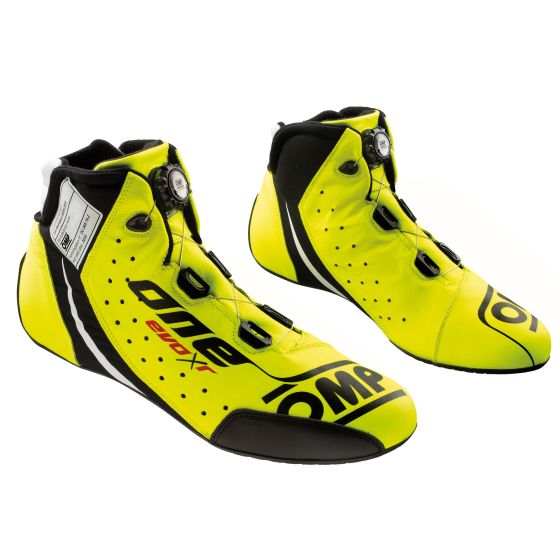 Fluro yellow racing boots with black accents, featuring a sleek design, lace-up closure, and reinforced toe, labeled "OMP One Evo X R," size UK 10.5 / EUR 45.