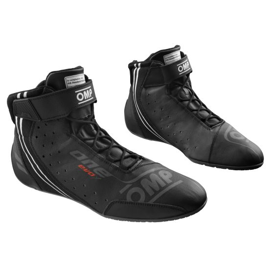 Black OMP One Evo X race boots made of leather, featuring a high-top design, perforated detailing for breathability, and a secure lace-up closure with ankle support. Size UK 5 / Eur 38.