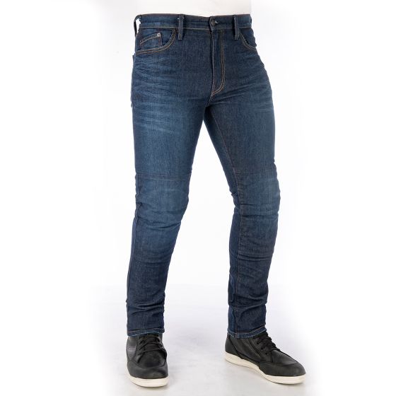 Dark aged slim-fit motorcycle jeans in blue denim, featuring reinforced knee panels and five-pocket design, paired with black sneakers.