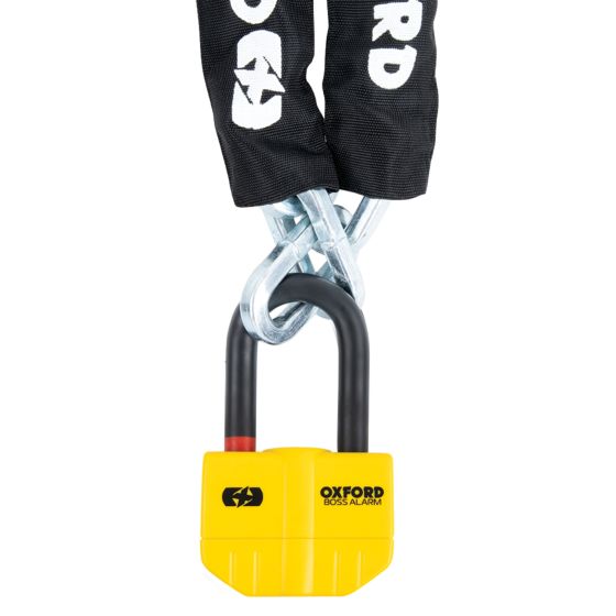 Yellow Oxford Boss Alarm lock attached to a thick black chain, featuring a sturdy design with a prominent logo and a secure locking mechanism.