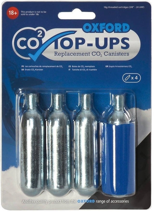 Four silver CO2 canisters with threaded tops, accompanied by a blue plastic sleeve, packaged in a clear plastic blister pack labeled "OXFORD CO2 TOP-UPS."