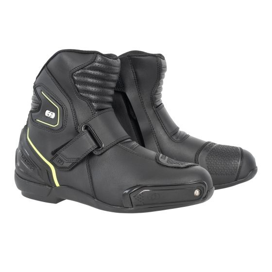 Black short boots with white and yellow accents, made of synthetic material, featuring a textured toe cap, adjustable strap, and padded ankle for comfort and support.