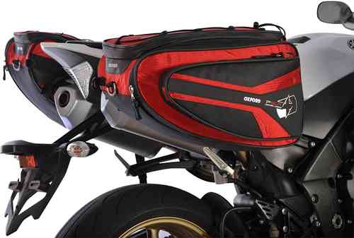 Red and black Oxford P50R motorcycle panniers, 50L capacity, featuring a sleek design, durable material, and reflective accents, mounted on a motorcycle's rear.