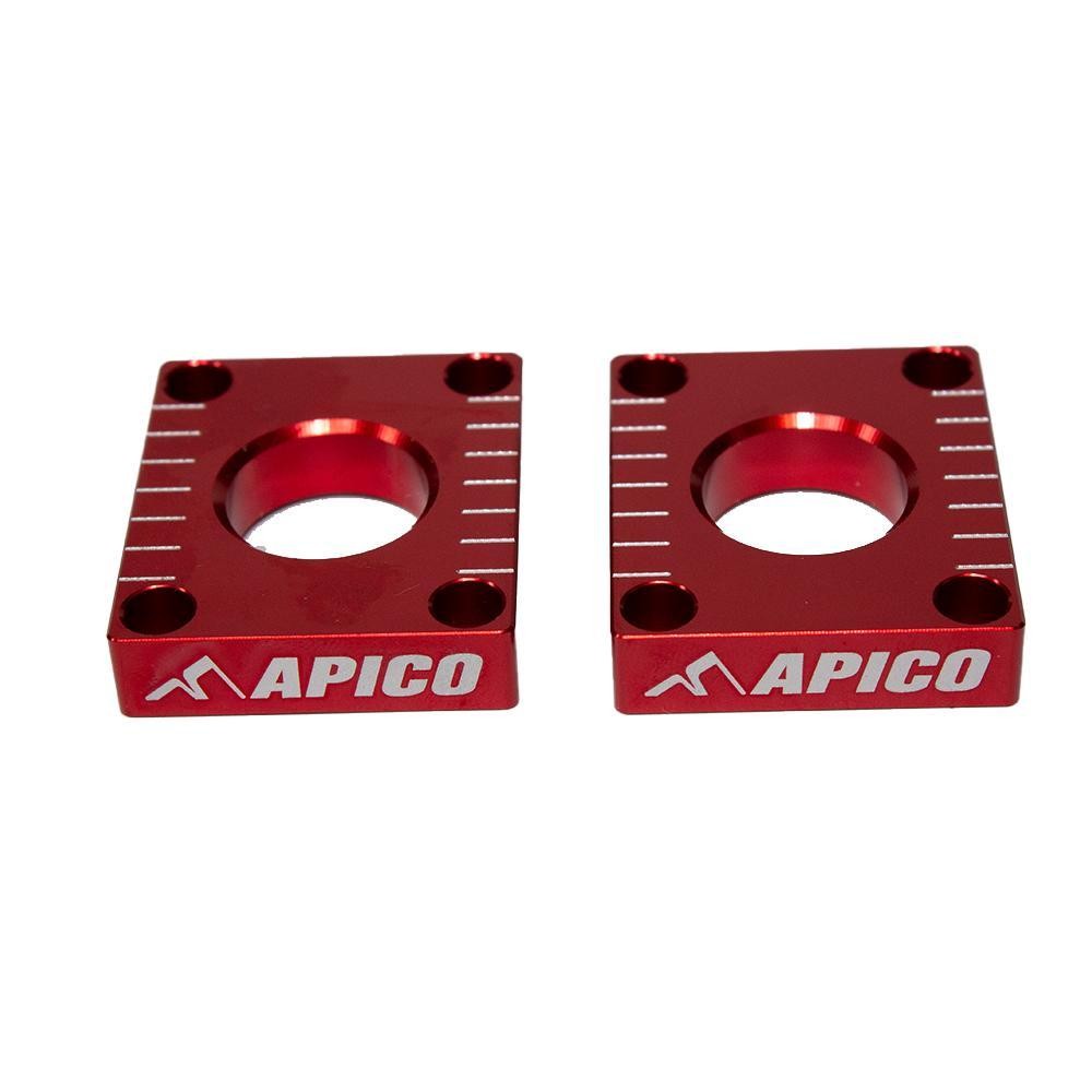 Red aluminum rear axle blocks with engraved Apico logo, designed for Honda CRF250L (2013-2021) and CRF300L (2021-2023), featuring alignment markings and a sleek finish.