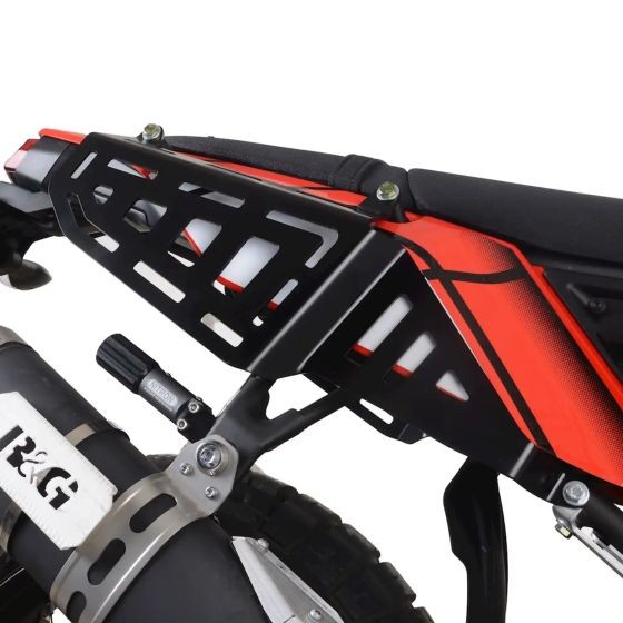 Black metal side rails with a sleek design, featuring cut-out patterns, mounted on a motorcycle, complementing red and black bodywork.