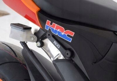 Black R&G Motorcycle Rear Footrest Blanking Plates with silver hardware, featuring an HRC logo, designed to cover unused footrest mounts on sport bikes.
