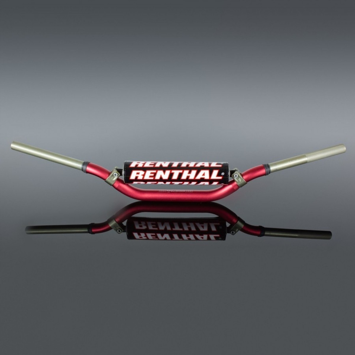 Red Renthal 996 Twinwall handlebars with a distinctive Villopoto/Stewart bend, featuring aluminum construction and a glossy finish, displayed against a reflective surface.