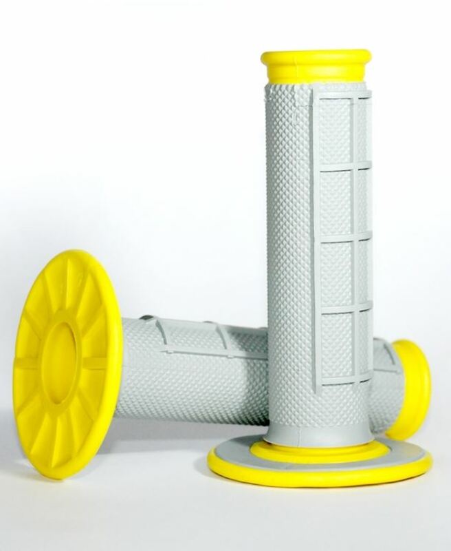 Grey dual compound motocross grips with a waffle texture and bright yellow end caps, featuring a ribbed design for enhanced grip and control.