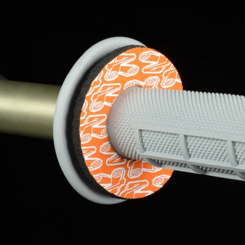 Orange and white Renthal Donuts grip pads, made of rubber, featuring a textured surface and a circular design, designed to enhance grip on motorcycle handlebars.