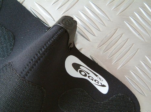 Black neoprene face mask with a smooth finish, featuring a prominent "Foggy" logo, adjustable clip, and textured patches for a secure fit.