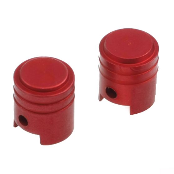 Red alloy valve caps with a piston shape, featuring a smooth top and a small hole on the side, designed for durability and style.