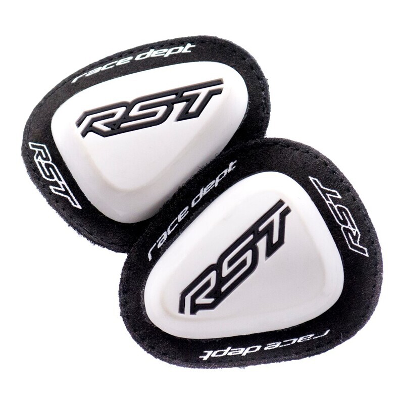 White motorcycle elbow sliders with a black suede backing, featuring the RST logo in black and white, designed for enhanced grip and protection in racing.
