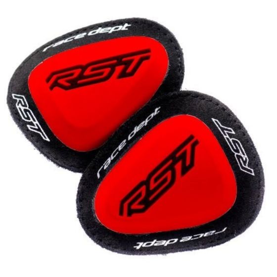 Red elbow sliders with a smooth surface and black fabric backing, featuring the "RST" logo prominently displayed in black on a vibrant red background.