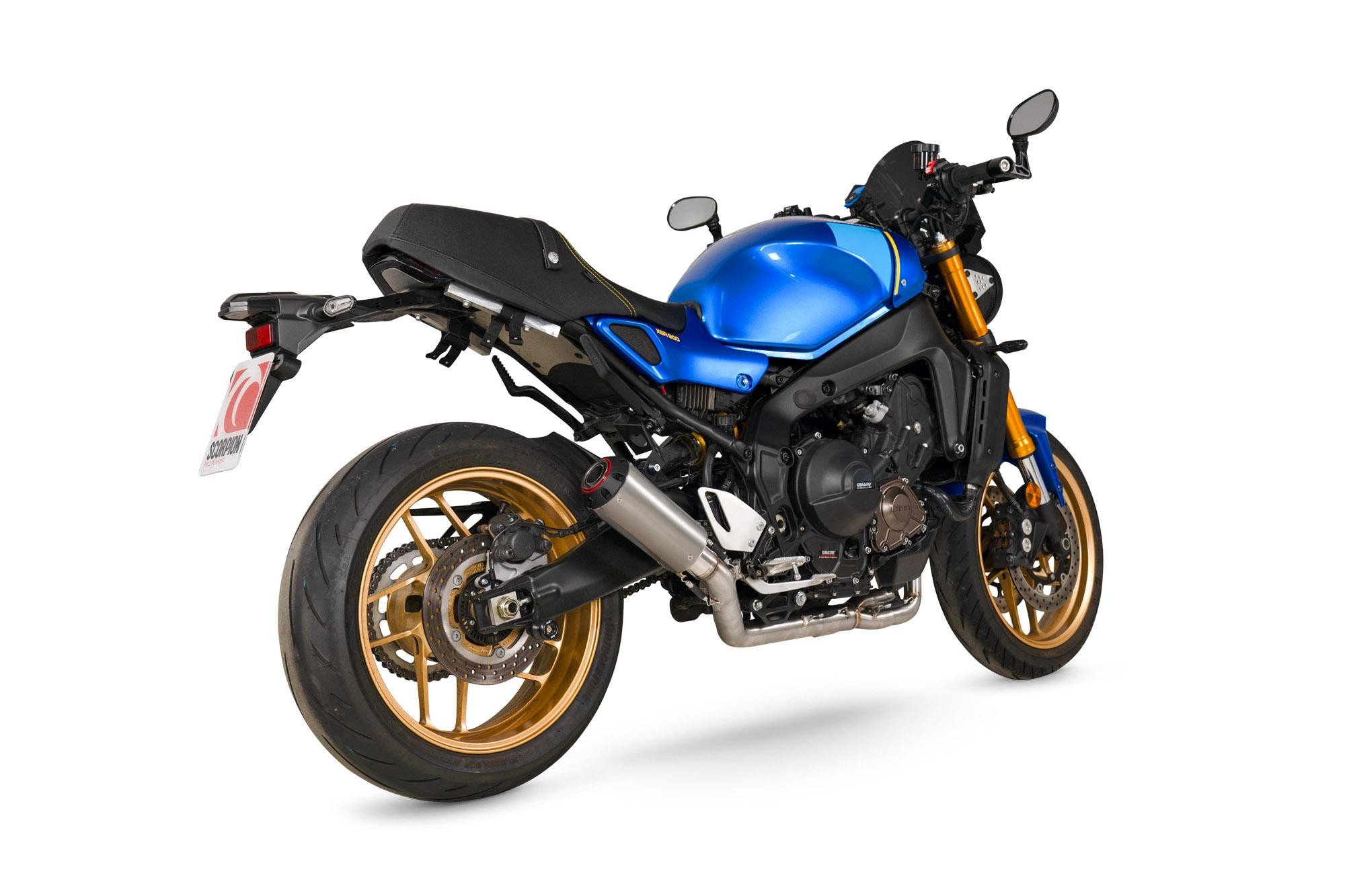 Scorpion Red Power Full System Titanium exhaust for Yamaha XSR 900, featuring a sleek design with a metallic finish and distinct gold rims on a blue motorcycle.