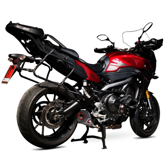 Scorpion Serket Taper Silencer featuring a sleek stainless steel sleeve, mounted on a red motorcycle with a black seat and luggage rack, showcasing a modern design.