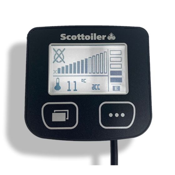 Scottoiler ESystem V3.1 display unit features a black casing with a digital screen showing temperature, oil level, and settings icons, alongside a connecting cable.