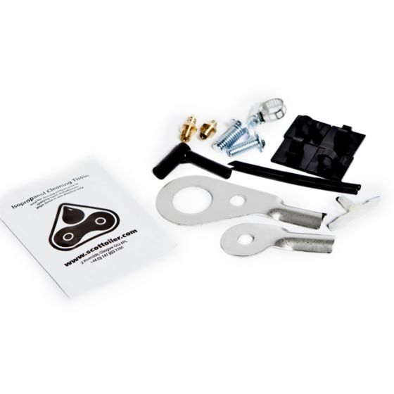 Scottoiler VSystem Spares Kit Bag includes metal tools, screws, a cleaning tool, and a black plastic component, accompanied by an instruction leaflet featuring the Scottoiler logo.