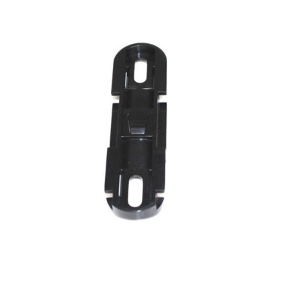 Black plastic mounting block assembly with a sleek design, featuring two elongated slots and a central raised section for secure attachment in the Scottoiler XSystem.