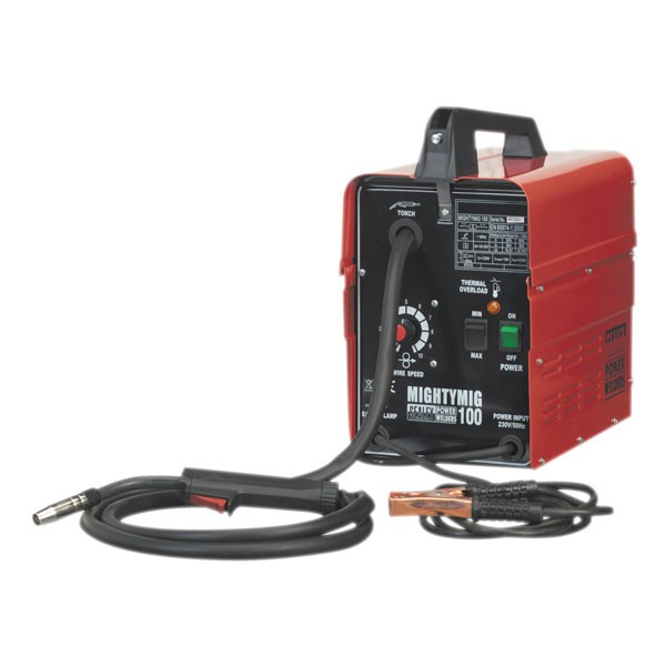Red and black MIG welder with a sturdy handle, featuring a control panel with dials and indicators, and a welding torch with a cable and clamp attached.