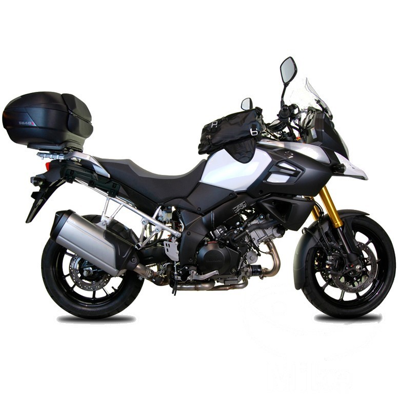 Black SHAD Top Master Topcase Carrier mounted on a sleek silver motorcycle, featuring a sturdy design and integrated mounting system for secure luggage transport.