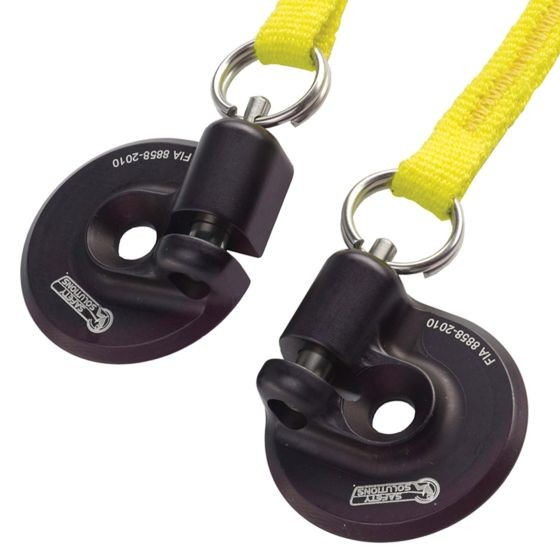 Black metal helmet anchors with a circular design, featuring a quick-release mechanism, attached to bright yellow straps for easy visibility and use.