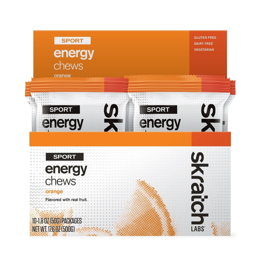 Skratch Labs Fruit Drops in orange packaging, featuring two clear pouches labeled "Sport Energy Chews," highlighting gluten-free, dairy-free, and vegetarian attributes.