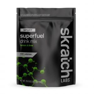 Black pouch with green accents, featuring "Skratch Labs Sport Superfuel Mix - Lemon and Lime" text, highlighting 400 calories, with a textured design and a resealable top.