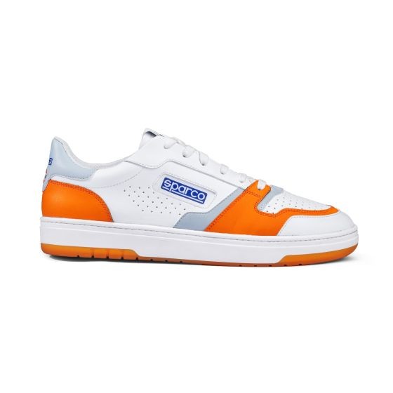 White leather sneakers with orange and grey accents, featuring perforated details, a padded collar, and a rubber sole, labeled with the Sparco logo. Size UK 9.5 / EUR 44.